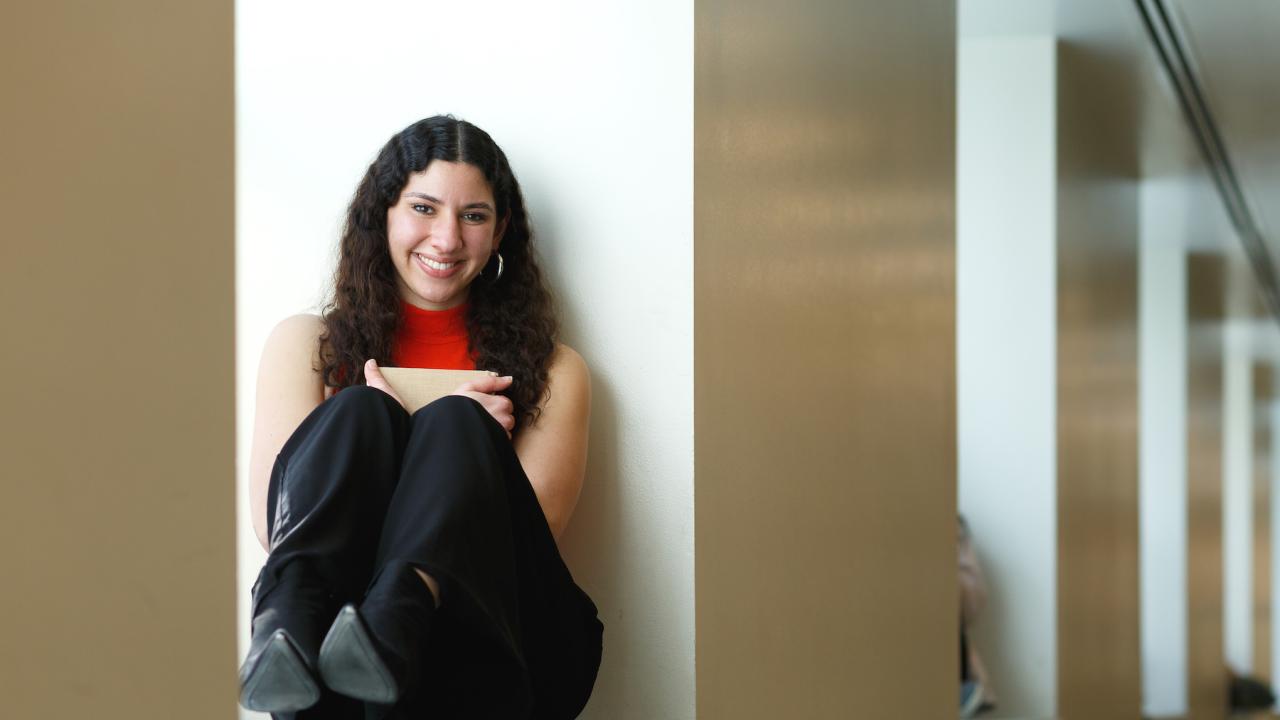 Jumana Esau seated in a window in Shields Library
